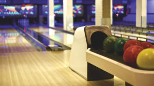 bowling alley with blurred lanes and balls in focus